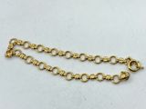 a close up of a gold chain on a white surface