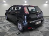 the back end of a small black car on a checkered floor