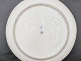 a white plate with a clock on it on a table