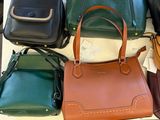 a lot of purses and shoes on a table