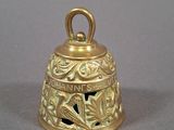 a gold bell that is sitting on a table