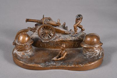 bronze statue of a man with a gun and a man on a cart