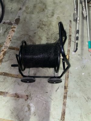 a spool on the ground next to a bike