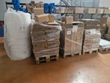 many boxes and pallets stacked on pallets in a warehouse