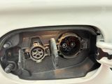 a close up of a car ' s fuel tank with the fuel plugged in