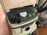 a dust extracter sitting on the floor next to a trash can