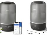 an image of a picture of a smart speaker with a phone next to it