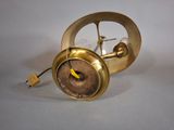a gold clock that is sitting on a table