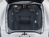 the trunk of a white sports car with its hood open