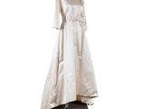 an image of a dress on a stand on a white background