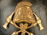 a black helmet with a gold emblem on it