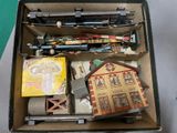 a box full of toy train tracks and other items