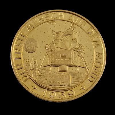 gold coin with the image of a man on a boat on the water