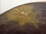 a close up of a piece of art with a bird on it