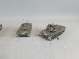 three toy tanks that are sitting on a table