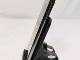 a cell phone that is on a stand on a table