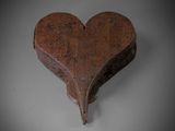 an old wooden heart shaped box sitting on top of a table