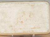 a small white plate sitting on a wooden table