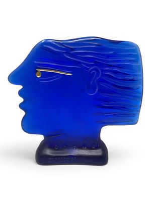 a blue glass sculpture of a woman ' s face on a stand