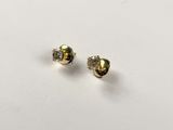 a pair of gold and diamond stud earrings on a white surface