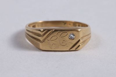 a close up of a gold ring with a diamond on it