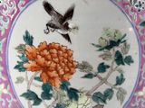 a vase with a picture of a bird and flowers on it