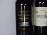 two bottles of wine sitting next to each other on a table