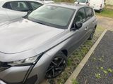 a silver car parked in a parking lot next to other cars