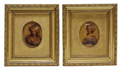 two framed portraits of a man and a woman in a gold frame