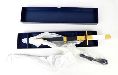 a knife in a blue box with a gold handle