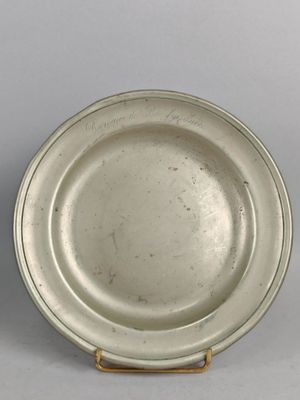 paire de plats en argent plaqué sur un socle, sur fond gris avec un fond blanc