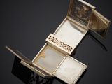an antique silver box with a mirror and two compartments on a black surface