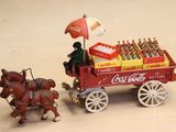 a miniature coca cola cart with a horse and carriage