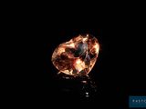 a close up of a diamond on a black surface
