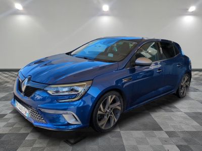 a blue car is parked on a checkered floor in a garage