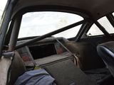 an old car with a broken steering wheel in the back