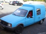 a blue van that is parked on the side of the road