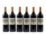six bottles of wine are lined up on a white surface