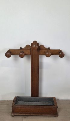 an old wooden cross with a stone in the middle of it