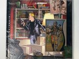the cover of a comic book with a picture of a man standing in front of a tv