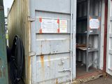 a metal container with a door open on the ground