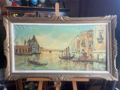 a painting of a gondola on a easel in front of a painting