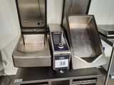 three stainless steel sinks on a table in a kitchen