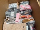 a cardboard box filled with lots of clothes and shoes