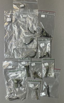 many bags of assorted items hanging on a wall