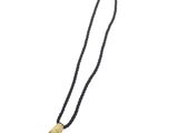 a black and gold necklace with a shell pendant on it