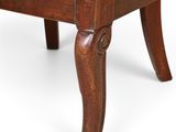 an old wooden chair with a red and gold upholstered seat