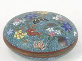 a blue box with flowers on it sitting on a white surface