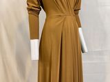an image of a mannequin wearing a brown dress on a mannequin stand