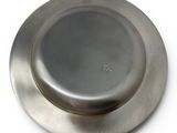 a silver plate on a white surface with a white background